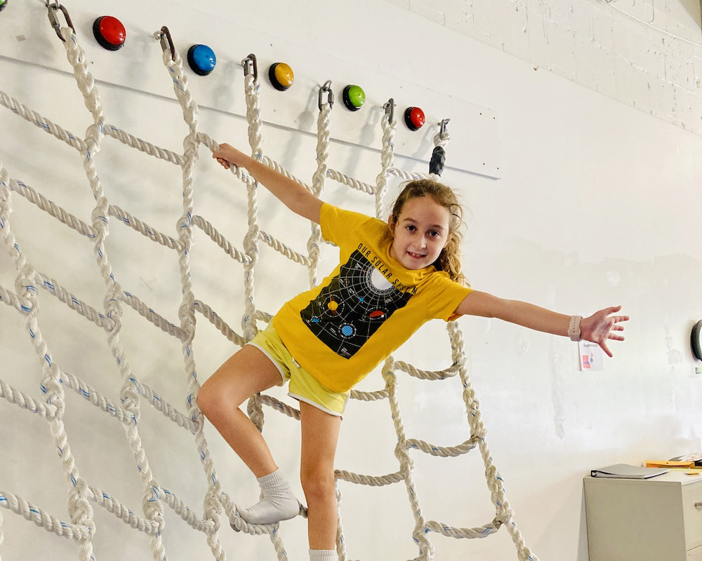 girl climbing rope ladder